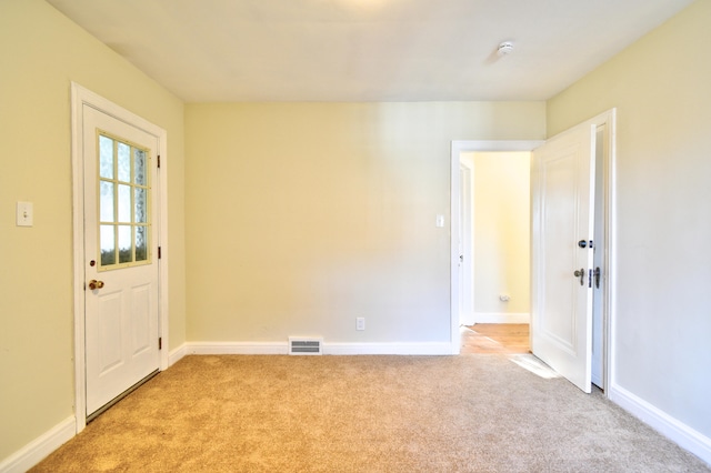 empty room featuring light carpet