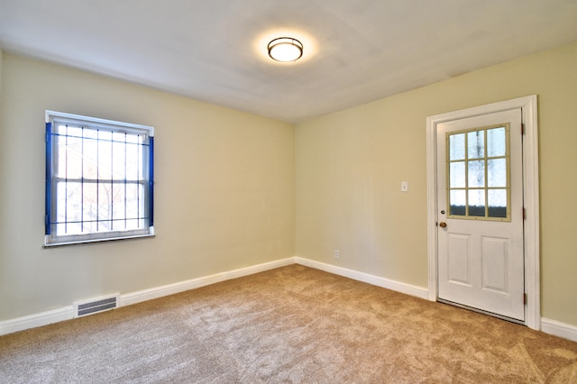 spare room with light colored carpet