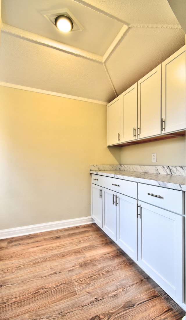 laundry room featuring crown molding and light wood-type flooring