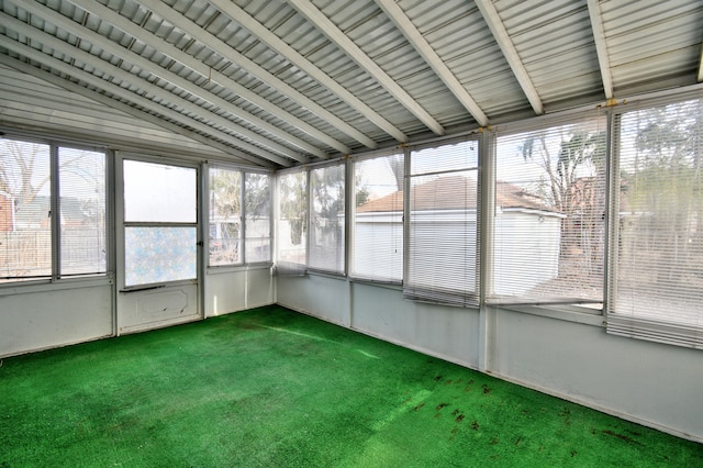 unfurnished sunroom with a healthy amount of sunlight and lofted ceiling