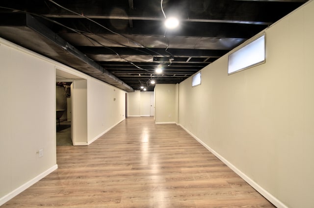 basement with light hardwood / wood-style floors