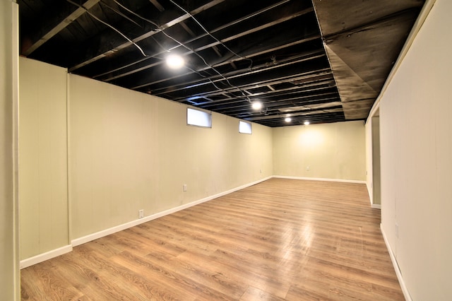 basement with hardwood / wood-style flooring