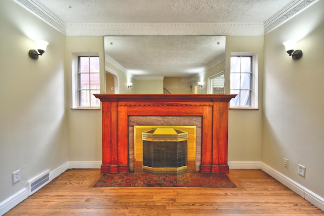 details featuring hardwood / wood-style flooring, ornamental molding, and a textured ceiling