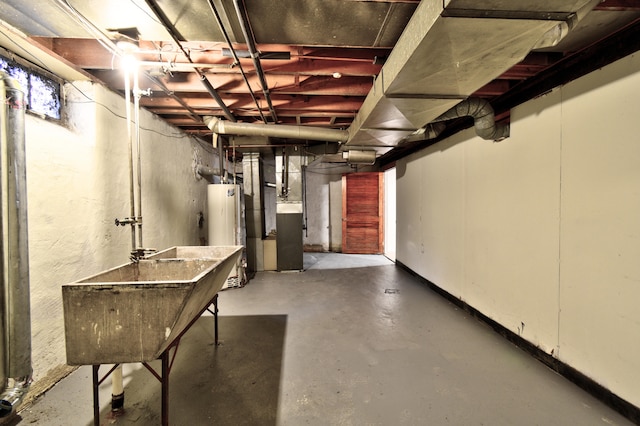 basement with heating unit, sink, and water heater