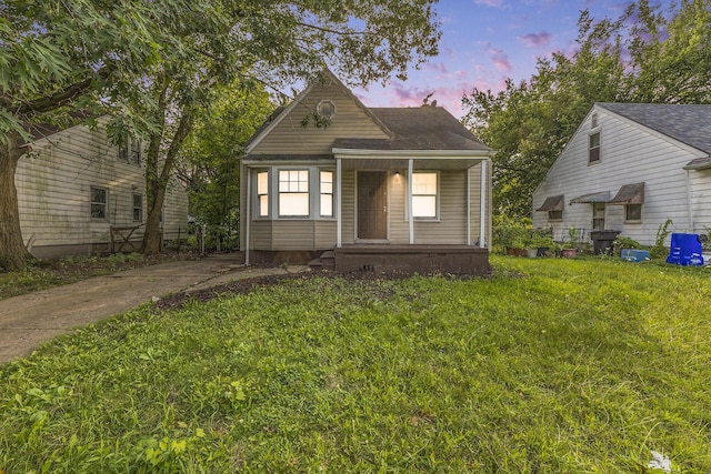 view of front facade with a porch and a yard