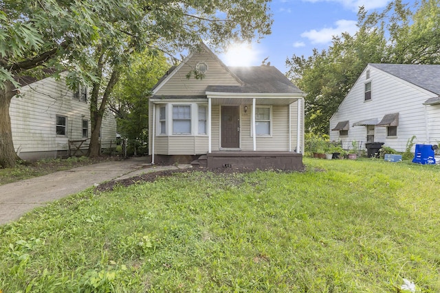 view of front of home featuring covered porch and a front yard