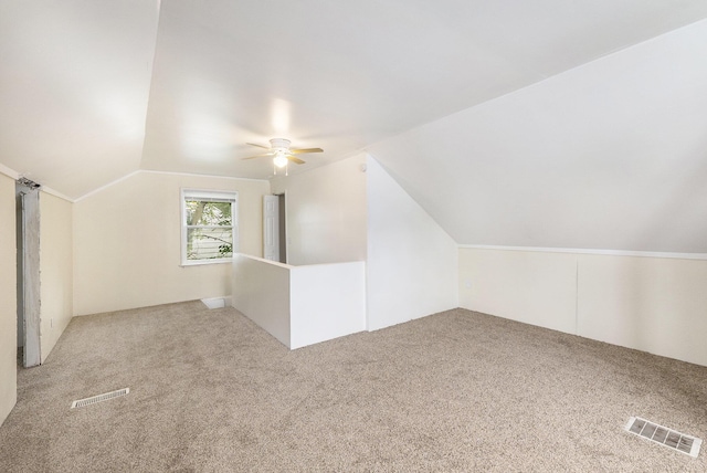 additional living space with carpet, ceiling fan, and vaulted ceiling