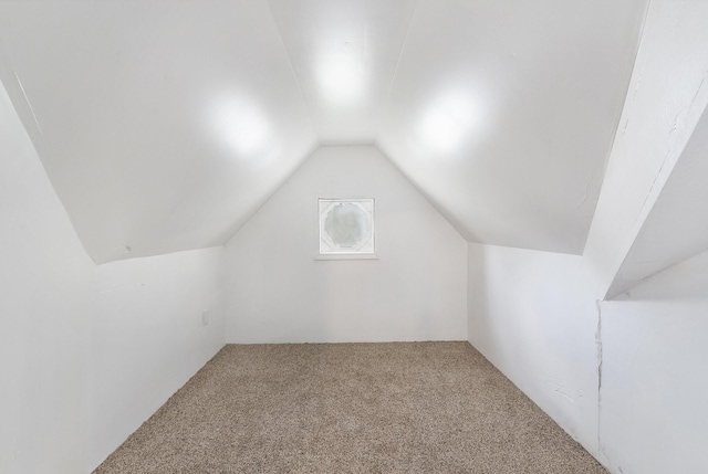 bonus room with lofted ceiling and carpet floors