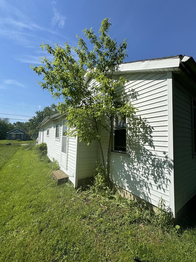 view of property exterior with a lawn