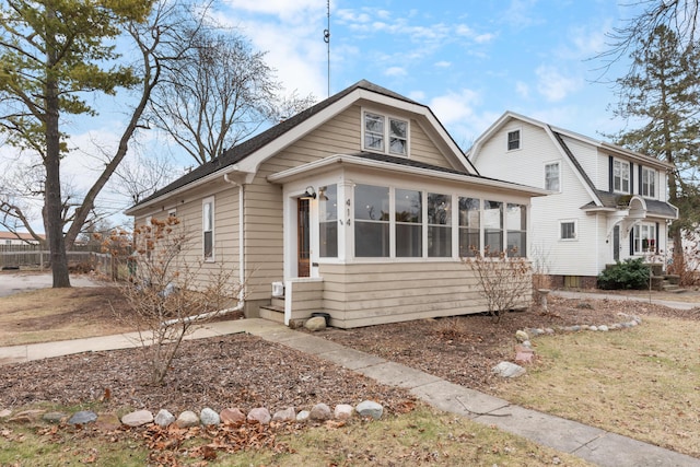 view of front of house featuring a sunroom