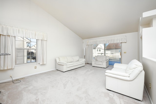 living room featuring carpet flooring, high vaulted ceiling, and plenty of natural light