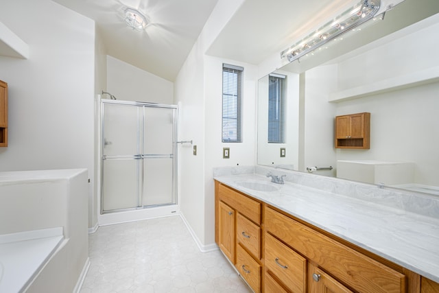 bathroom with tile patterned flooring, vanity, and walk in shower