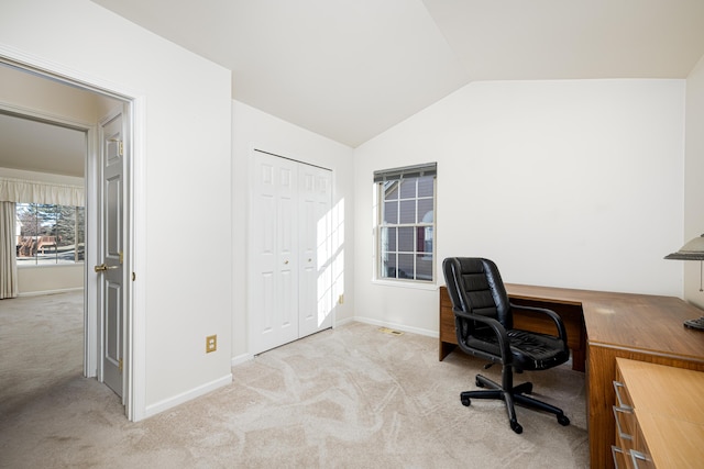 office with light colored carpet and vaulted ceiling