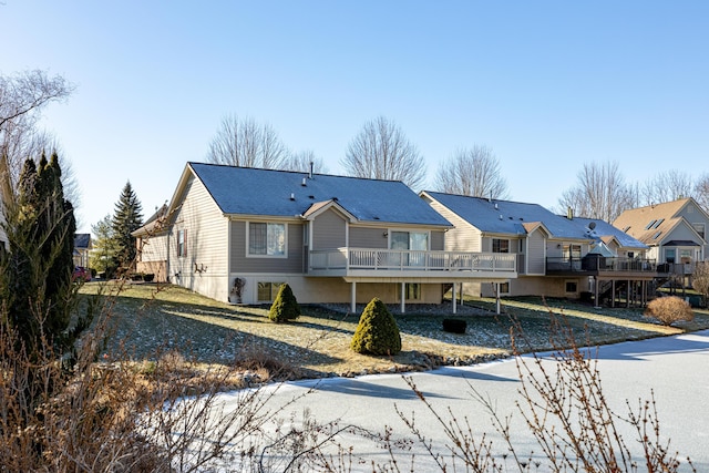 rear view of house featuring a wooden deck