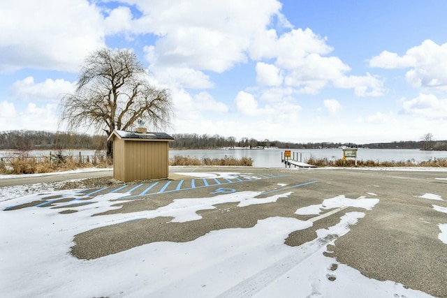 view of yard with a water view and a shed