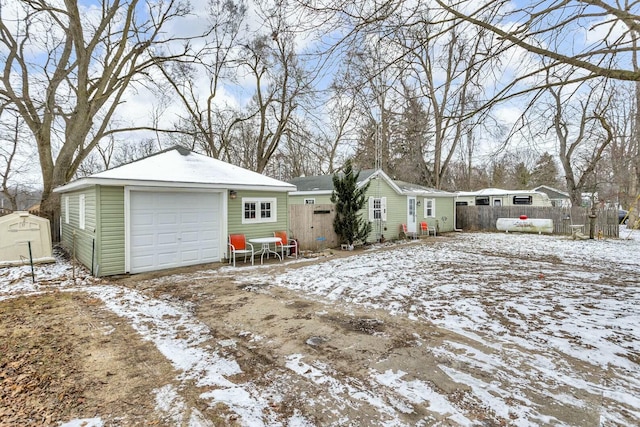 exterior space with a garage and an outdoor structure