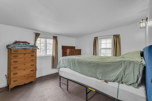 carpeted bedroom featuring multiple windows