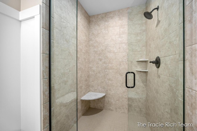 bathroom with a shower with shower door