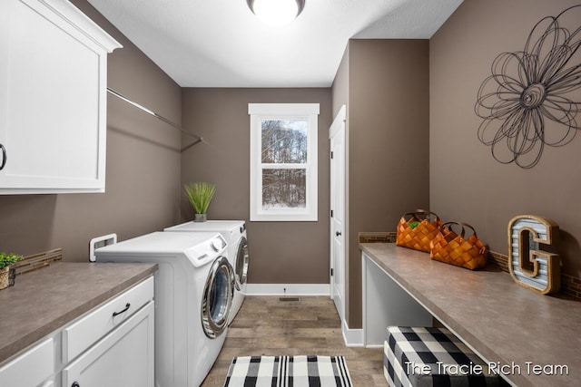 laundry room featuring independent washer and dryer, cabinets, and dark hardwood / wood-style flooring