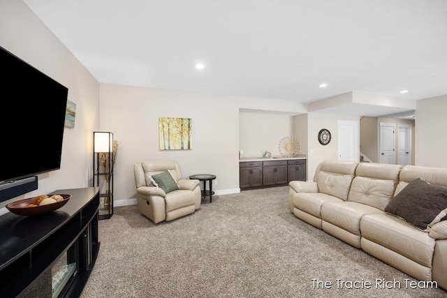 living room featuring sink and light colored carpet