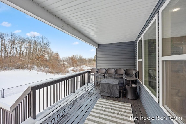 view of snow covered back of property