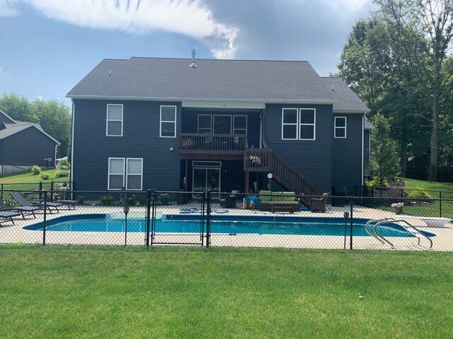 view of swimming pool featuring a patio area and a lawn