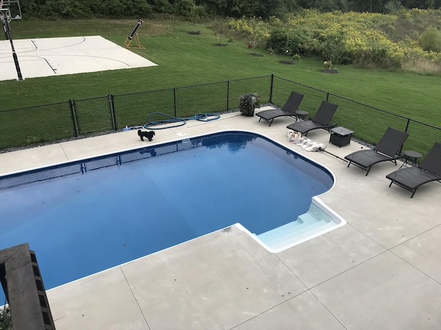 view of pool with a yard and a patio