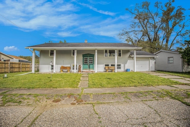 view of front of house with a front yard, a porch, and a garage