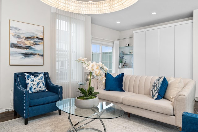 living room with a notable chandelier and light hardwood / wood-style floors