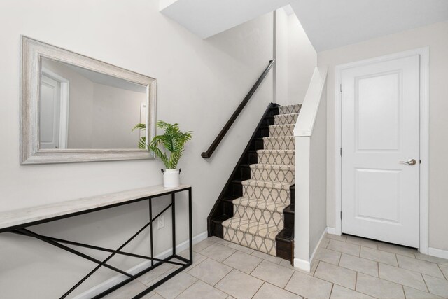 stairs featuring tile patterned flooring