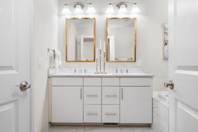 bathroom featuring a washtub and vanity