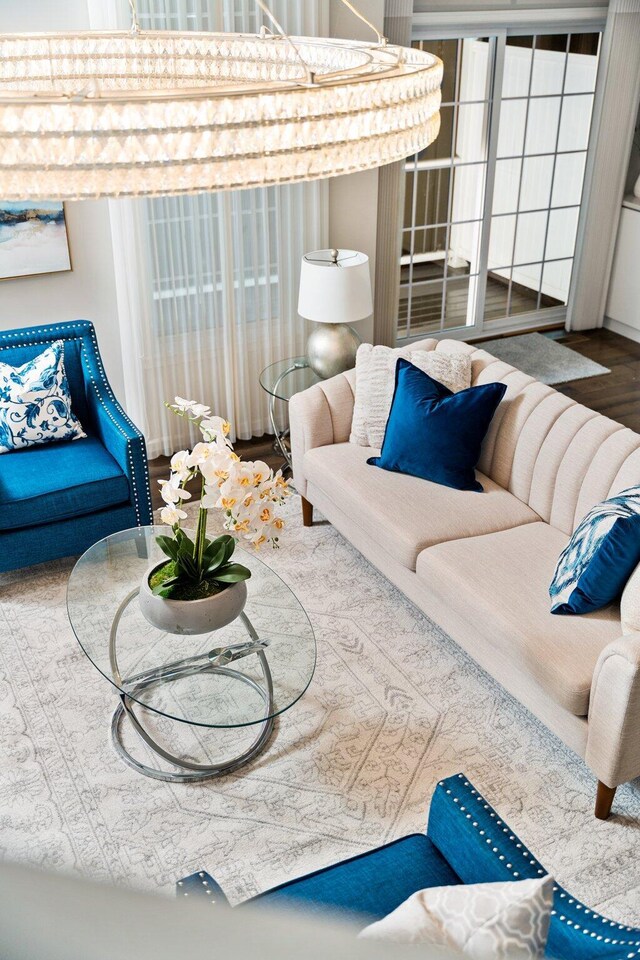 living room featuring a notable chandelier and wood-type flooring