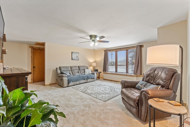 living room with ceiling fan and light colored carpet