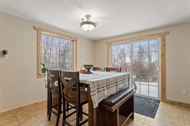 dining area featuring plenty of natural light and light tile patterned floors