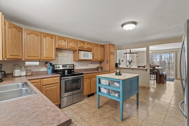 kitchen featuring sink, stainless steel appliances, and light tile patterned floors