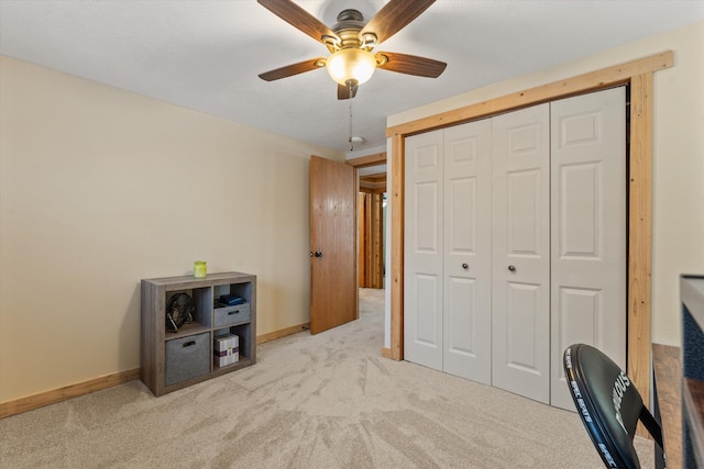 carpeted home office featuring ceiling fan