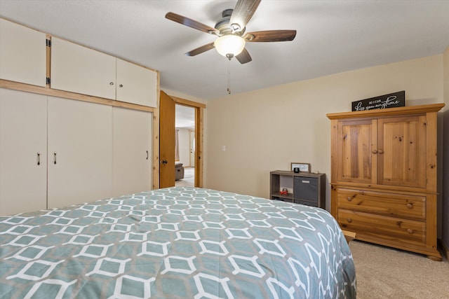 bedroom featuring a closet, light carpet, and ceiling fan