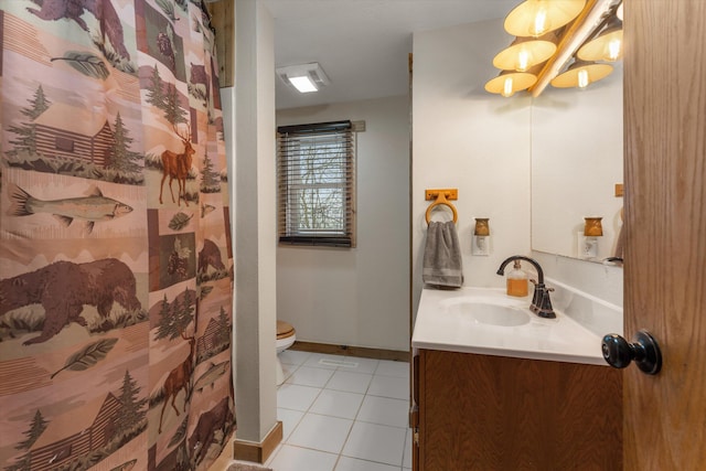 bathroom with tile patterned floors, vanity, and toilet