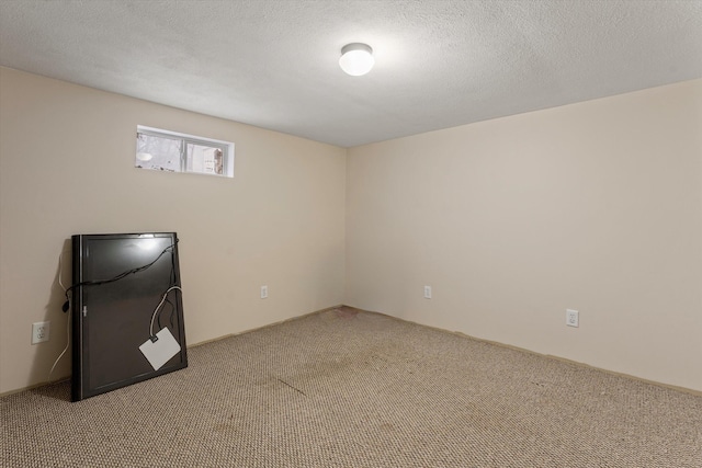 interior space with a textured ceiling and carpet floors