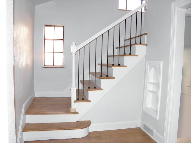 staircase featuring hardwood / wood-style flooring