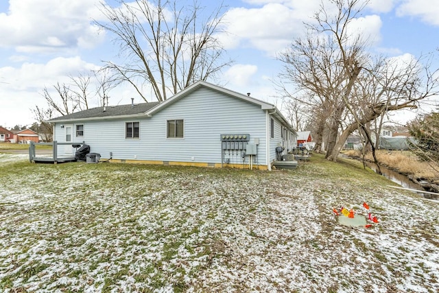 view of snow covered rear of property