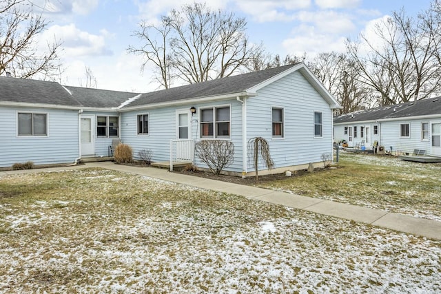 rear view of property with a lawn