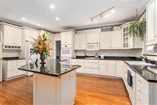119 Kingsbury Ct, Battle Creek, MI 49015 - kitchen featuring a center island, white cabinets, light hardwood / wood-style flooring, and appliances with stainless steel finishes