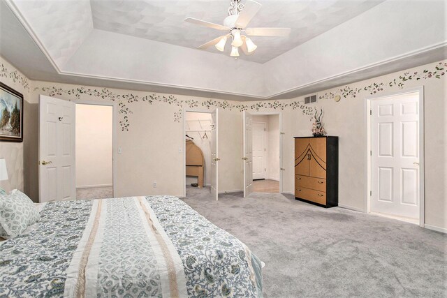 119 Kingsbury Ct, Battle Creek, MI 49015 - bedroom featuring a raised ceiling, ceiling fan, a spacious closet, light colored carpet, and a closet