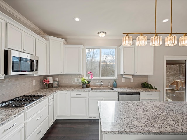 kitchen featuring sink, hanging light fixtures, dark hardwood / wood-style flooring, white cabinets, and appliances with stainless steel finishes