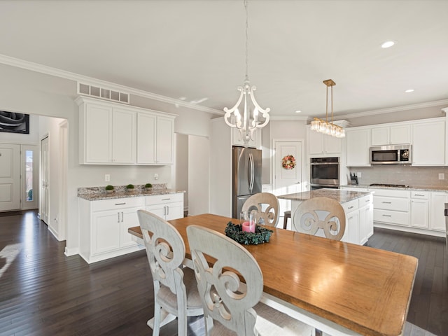 dining room with a notable chandelier, dark hardwood / wood-style floors, and ornamental molding