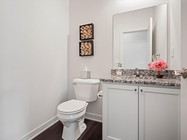 bathroom featuring hardwood / wood-style floors, vanity, and toilet