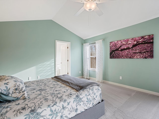 bedroom with ceiling fan, light colored carpet, and vaulted ceiling