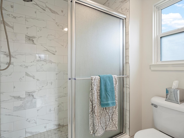 bathroom featuring toilet and an enclosed shower