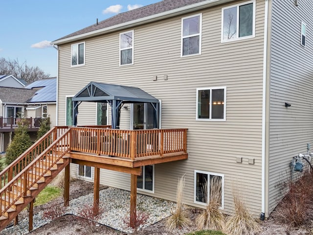 back of house featuring a wooden deck